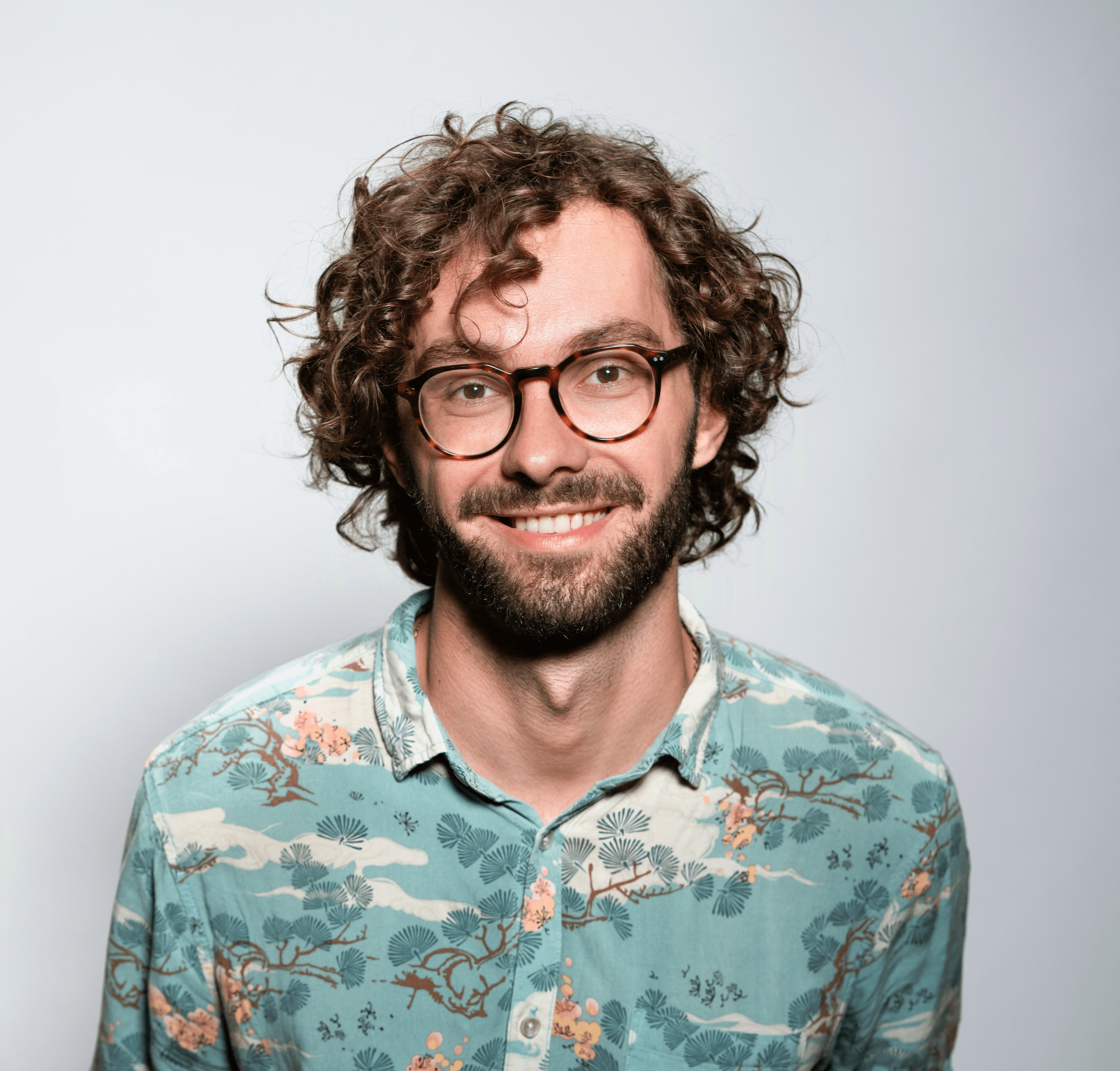 smiling man with glasses and beard portrait