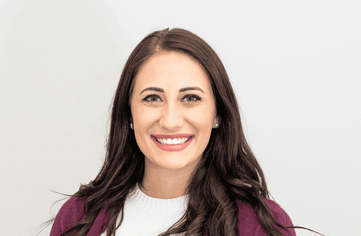 woman in red cardigan smiling